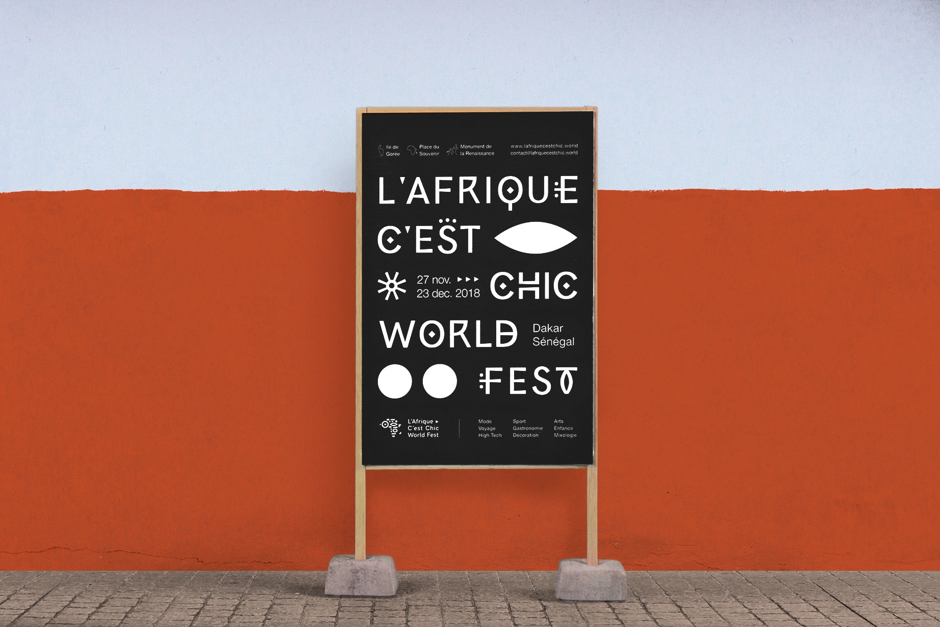 Affiche du festival l'Afrique c'est chic, installée sur un panneau avec un cadre en bois avec des pieds en béton devant un mur couleur terracotta